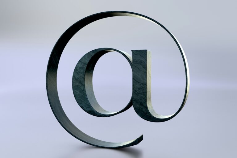 A large at symbol on a light reflective surface