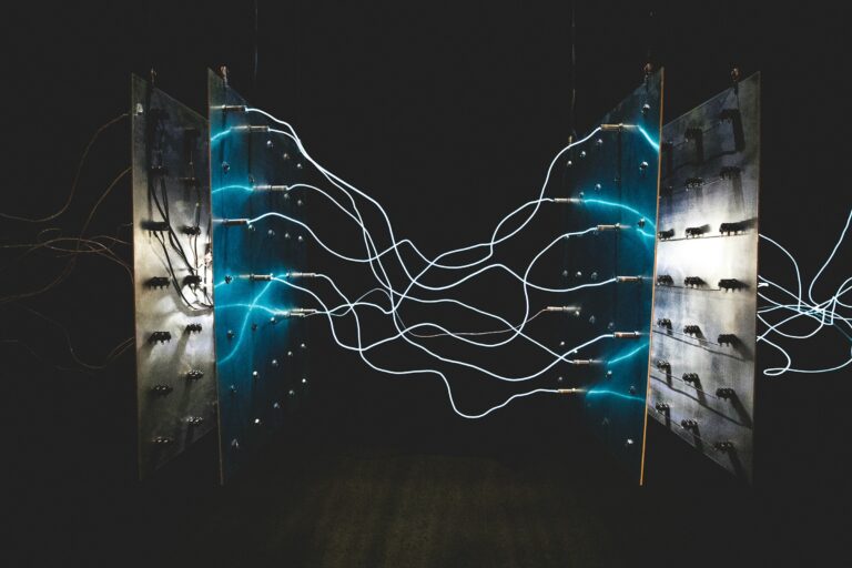 Bright blue electrical arcs connecting two metal panels