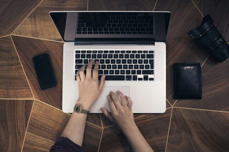A person working on a laptop at a desk