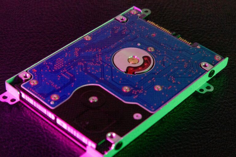 A hard disk drive lit in green and pink