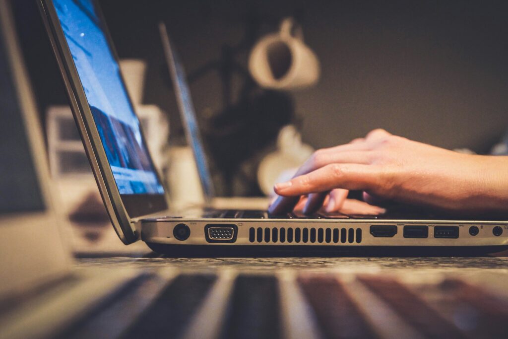 A person using a laptop at a desk