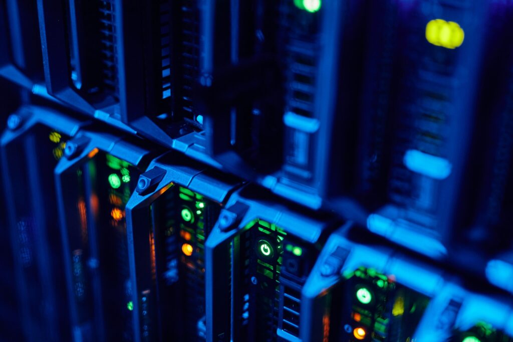 Rows of blade servers with green status lights in a data center