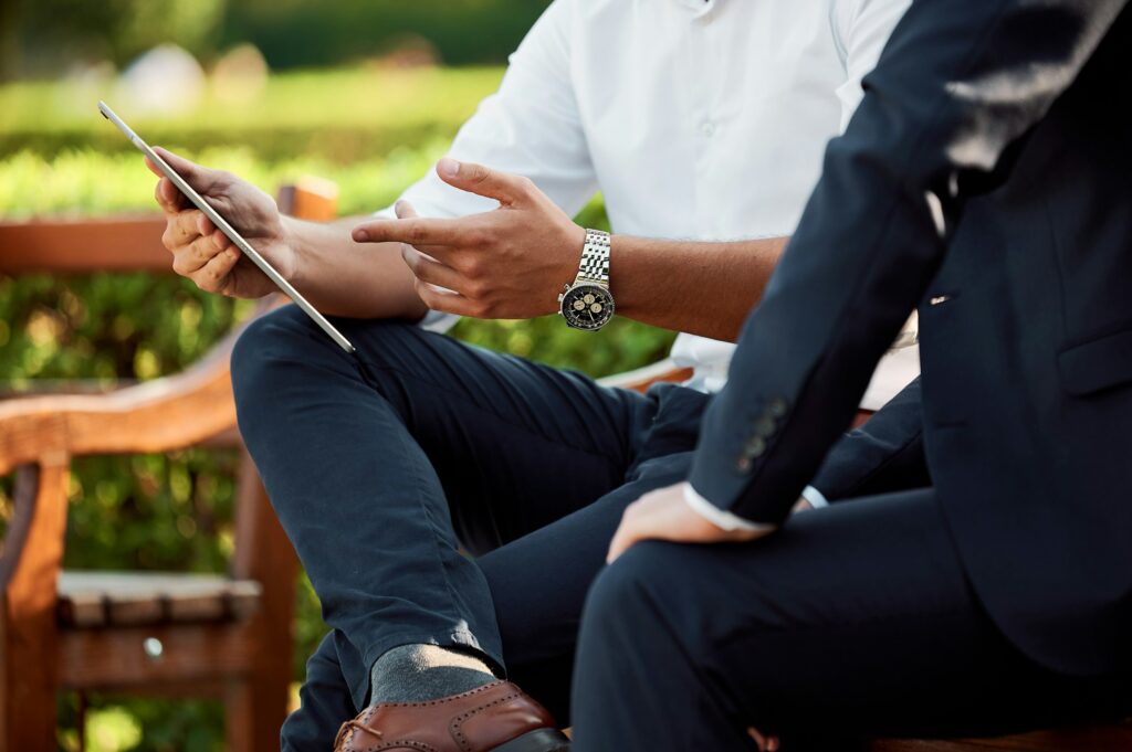 Two people talking through a project at a table