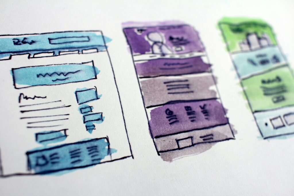 Watercolor wireframe sketches of website page layouts